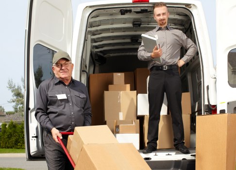Labeled boxes and furniture prepared for office relocation in Westkensington