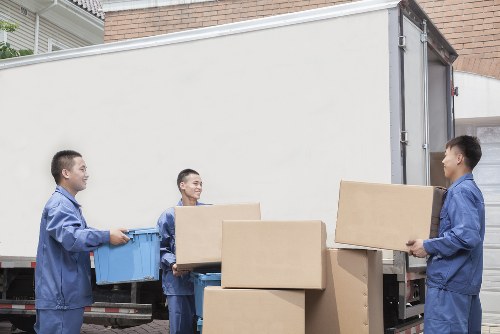 Local moving team carrying items through a Westkensington street