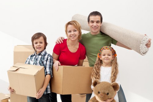 Professional movers protecting furniture during a house move