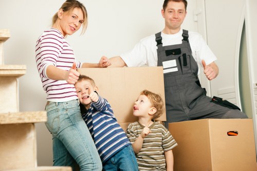 Professional moving team handling furniture with care in West Kensington